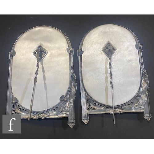 267 - A pair of WMF silver coloured easel photograph frames, each with a classical maiden with outstretche... 