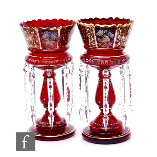 803 - A pair of late 19th Century ruby glass table lustres, each with a stepped circular foot, baluster st... 