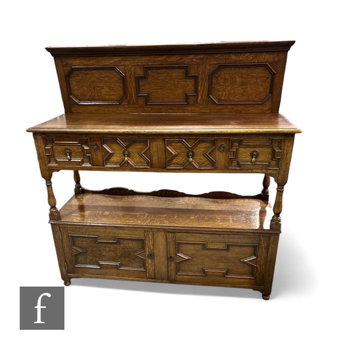 396 - A late 1920s light oak two tier buffet in the 17th Century style, fitted with two geometric moulded ... 