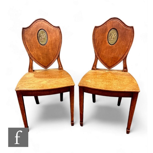 398 - A pair of late 19th Century mahogany hall chairs, plank seats below shaped backs inset with green ov... 