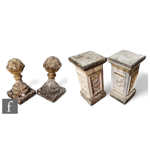 421 - A pair of composite stone ball finials on pedestal square bases, height 117cm. (2)