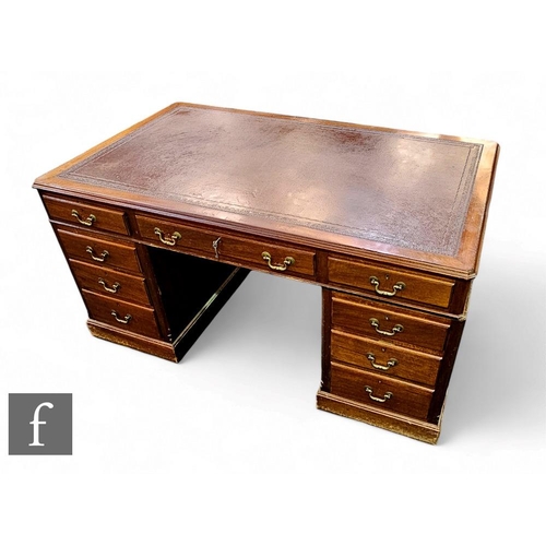 426 - A 1930s or earlier mahogany pedestal desk fitted with three frieze drawers below a moulded edge and ... 