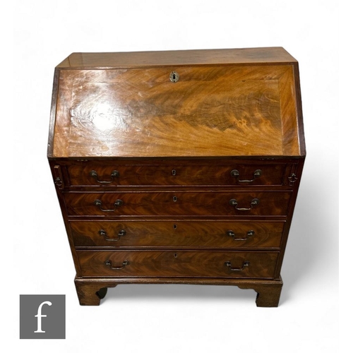 430 - A 19th Century mahogany bureau, the fall front enclosing an arrangement of drawers, above four long ... 