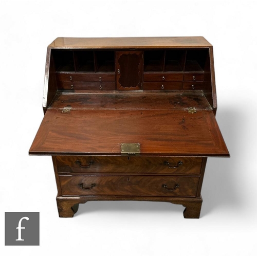 430 - A 19th Century mahogany bureau, the fall front enclosing an arrangement of drawers, above four long ... 