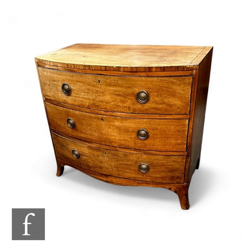 432 - A mahogany George III bow front chest of drawers, the plank top over three long drawers, with brass ... 