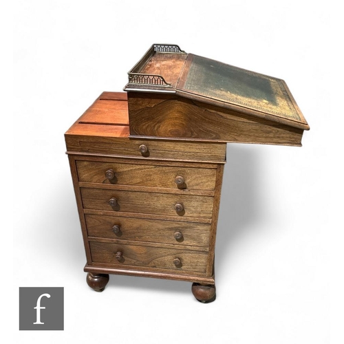 435 - A 19th Century rosewood slide top Davenport, the fall front with a brass pierced gallery, revealing ... 