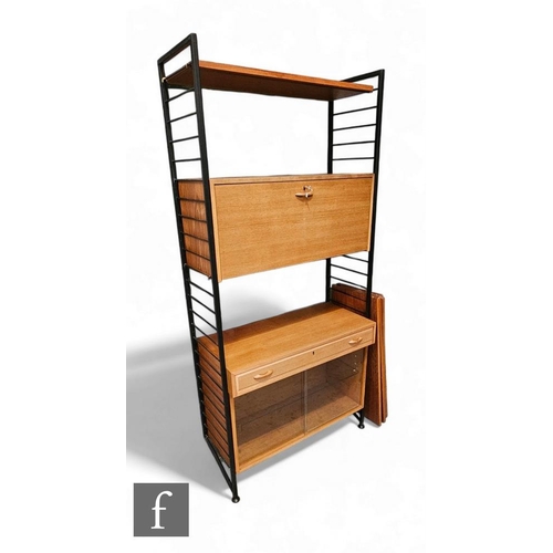 437 - A mid Century Ladderax shelving unit, the black metal frame with fall front cupboard, drawer and low... 