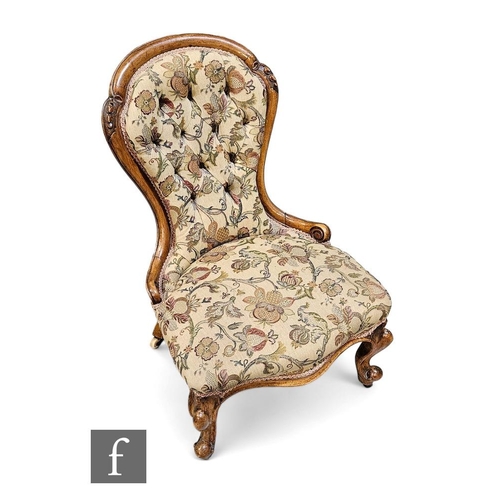 444 - A Victorian nursing chair, the mahogany spoon back frame raised on scrolling supports, with floral e... 