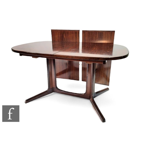 446A - A Robert Heritage for Archie Shine rosewood  dining table, the oval top raised on pillar supports, t... 