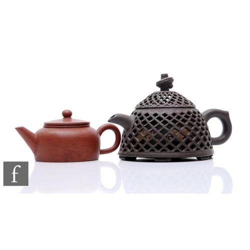 70 - Two Chinese Yixing teapot, the first as double-cased reticulated example painted with fish to the in... 