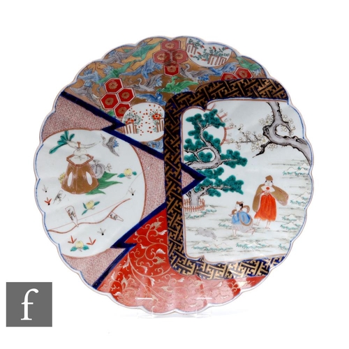 71 - An early 20th Century Japanese scalloped rim imari dish, the central field with segmented fan shaped... 