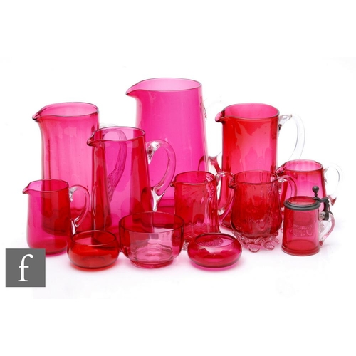 799 - A collection of late 19th and early 20th Century ruby or cranberry glass to include various jugs wit... 