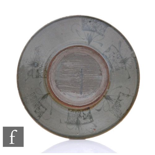 80 - A Chinese Tang Dynasty celadon dish, of circular form with gently sloped sides, with blue abstract d... 