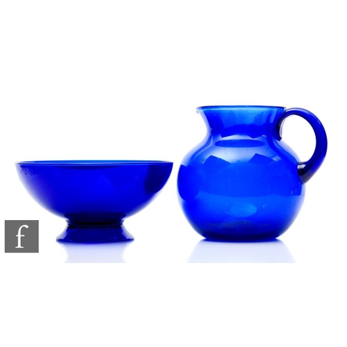 831 - A large Bristol Blue water jug of ovoid form with everted collar neck and hollow loop handle, height... 