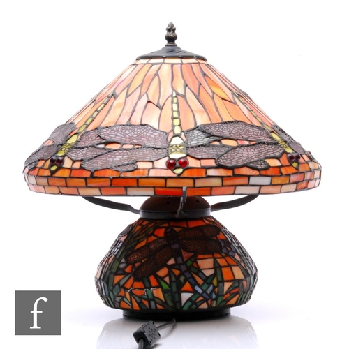 887 - A 20th Century reproduction table lamp in the manner of Tiffany, the compressed ovoid base decorated... 