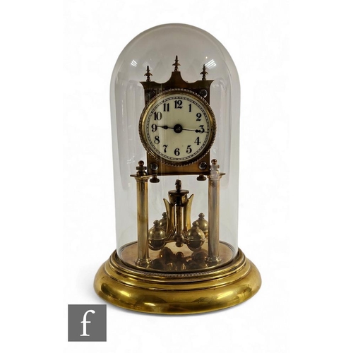 90 - An Edwardian 365 day brass pillar mantle clock, Arabic dial, on circular stepped base, height 30cm.