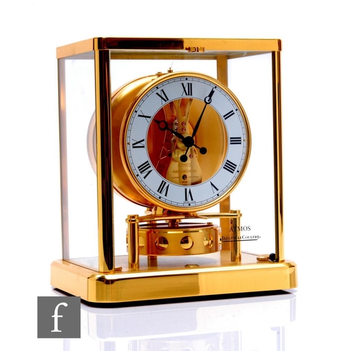 A Jaegar-Le-Coultre Atmos clock in brass edged glazed case, height 23cm.
