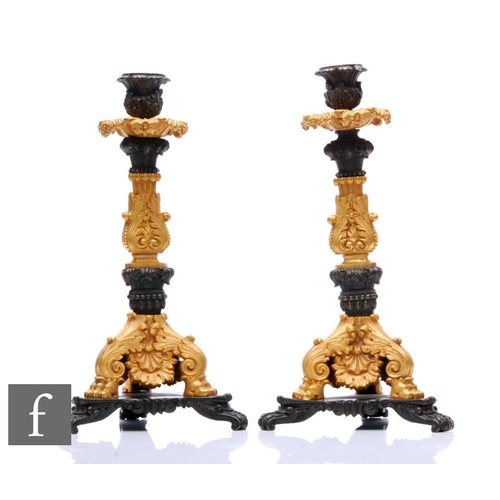 248 - A pair of French Empire style bronze and ormolu cast bronze candlesticks, scroll feet and tricorn ba... 