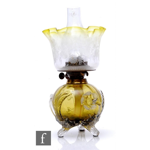 891 - A late 19th Stourbridge glass oil lamp, the citron compressed ovoid and fluted body decorated with a... 