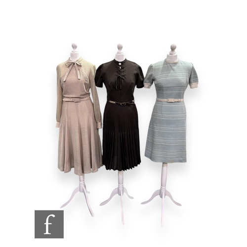 28 - Three 1970s vintage dresses, to include a short sleeve brown midi dress with lace up detail to the b... 