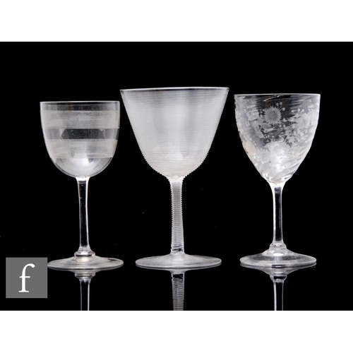 731 - A late 19th Century clear crystal wine glass, the ovoid bowl with fine engraved lines, engraved loze... 