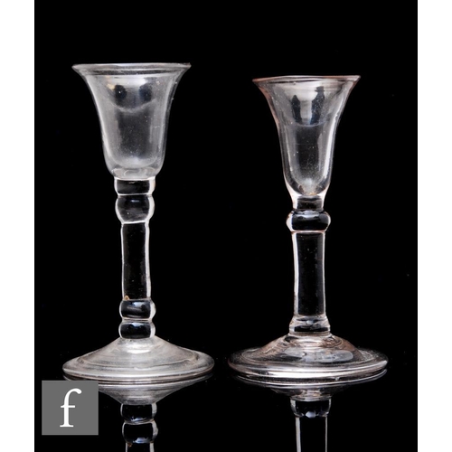 879 - An 18th Century baluster gin glass circa 1740, the slender bowl above an upper knop, solid plain ste... 