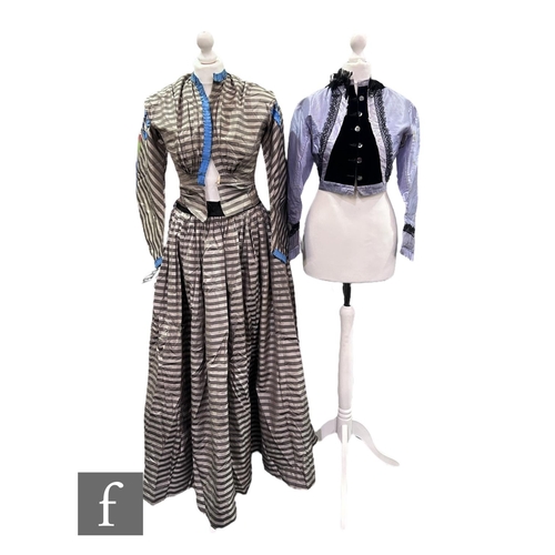 49 - A Victorian lady's two piece dress, the jacket with blue ruffle trim over grey and silver stripe fab... 