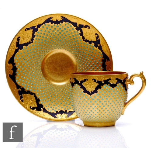 508 - A Coalport 'Jewelled' porcelain cup and saucer, richly decorated with a cobalt blue ground with tool... 