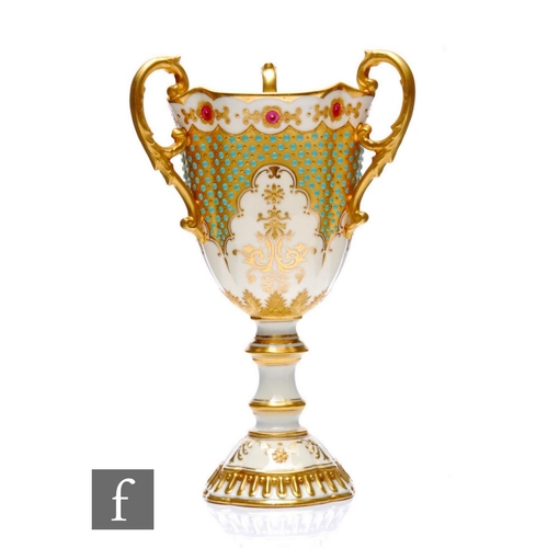 511 - A Coalport porcelain 'Jewelled' pedestal three-handled pedestal goblet, circa 1900, the white ground... 