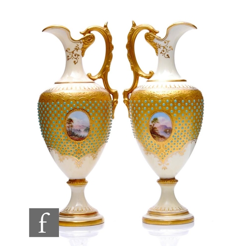 521 - A matched pair of Coalport porcelain ewers, circa 1900, each of pedestal form with acanthus loop han... 