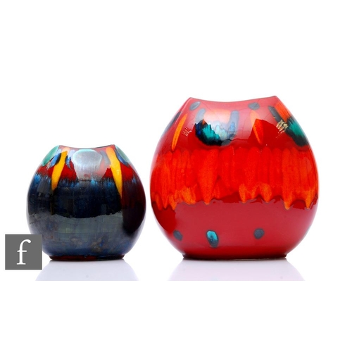 548 - Two later 20th Century Poole Pottery pillow vases, decorated with abstract patterns over the red and... 