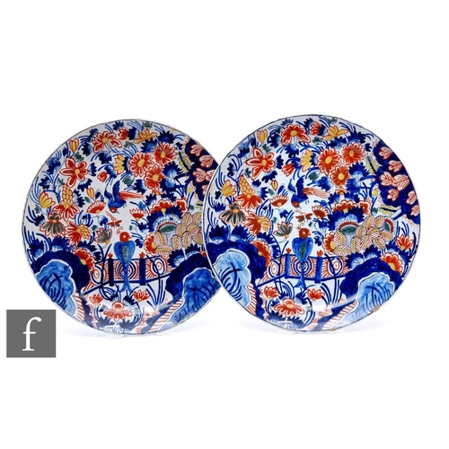 554 - A pair of 19th Century French faience plates, each of circular form decorated in the Chinese taste d... 