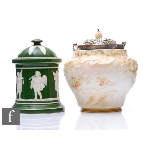 563 - A Doulton Burslem biscuit barrel, height 19cm, together with a green glazed relief moulded tobacco j... 