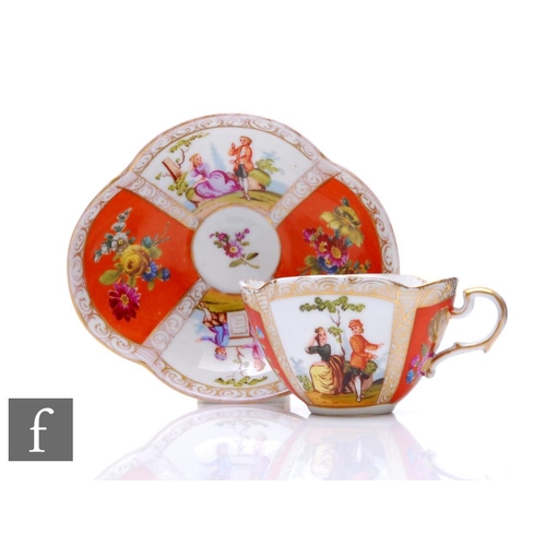 564 - An early 20th Century Dresden lobed cup and saucer the segmented orange and figural ground picked ou... 