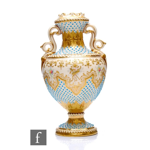 528 - A Coalport porcelain 'Jewelled' pedestal vase, circa 1900, the ivory ground heavily enamelled with t... 