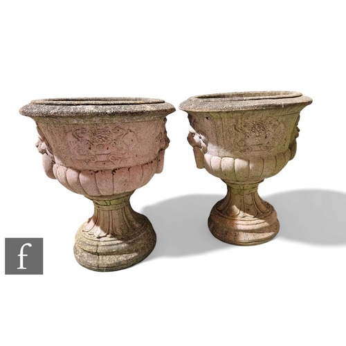 405A - A large pair of reconstituted garden urns, each of pedestal campana form with lion mask ring handles... 