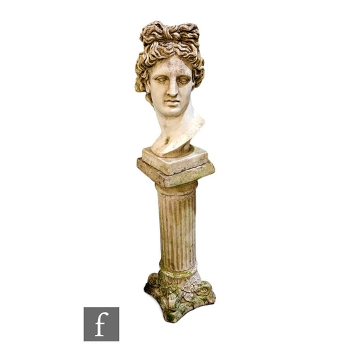 411A - A reconstituted stone bust of Apollo, raised on a Corinthian column pedestal.