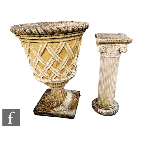 418A - A reconstituted stone garden urn of pedestal form with trellis work sides, height 69cm, together wit... 