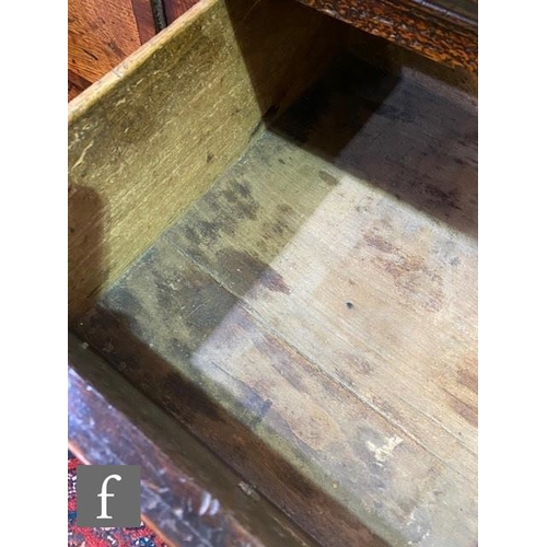 411 - A small 18th Century oak three drawer dresser base, mahogany crossbanded front, brass fret drop hand... 