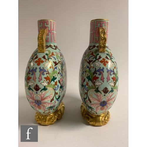 500 - A pair of late 19th Century Worcester moonflasks, each of flattened circular from, the upright neck ... 