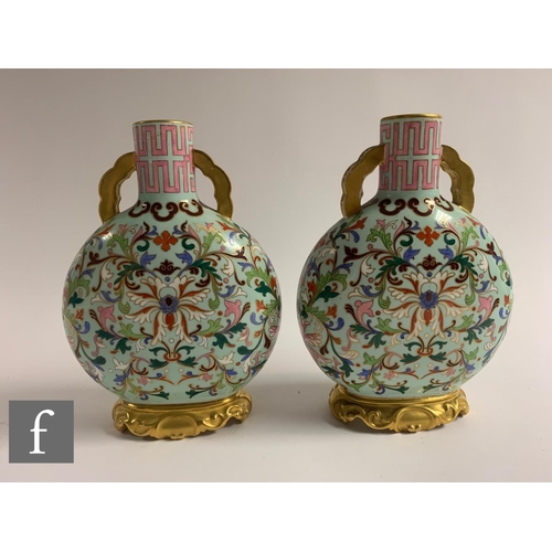 500 - A pair of late 19th Century Worcester moonflasks, each of flattened circular from, the upright neck ... 