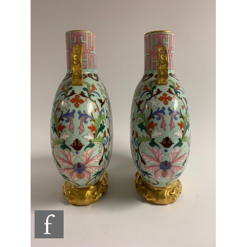 500 - A pair of late 19th Century Worcester moonflasks, each of flattened circular from, the upright neck ... 