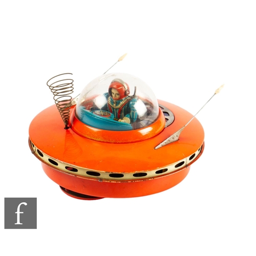 36 - A 1960s Japanese Yoshiya Flying Saucer, a battery operated tinplate toy in orange with plastic dome ... 