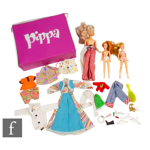 429 - Two Palitoy Pippa dolls, with a Flair Toys Daisy doll, with a selection of clothing in a Pippa carry... 