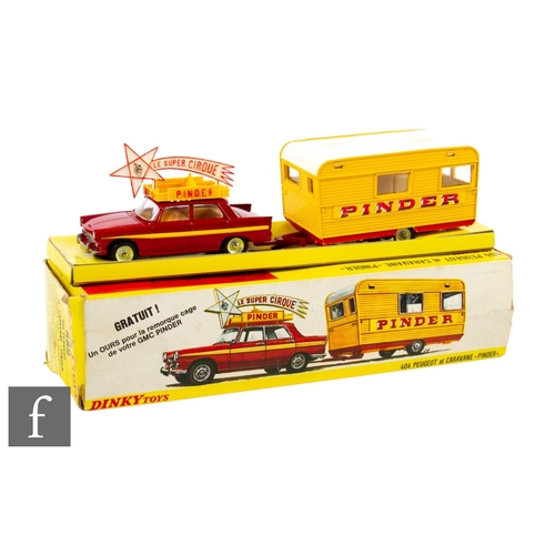 A French Dinky 882 Pinder Peugeot 404 & Caravan in red and yellow with light beige interior and concave hubs, the caravan yellow and red with cream roof, with bear, boxed with inner packing pieces.