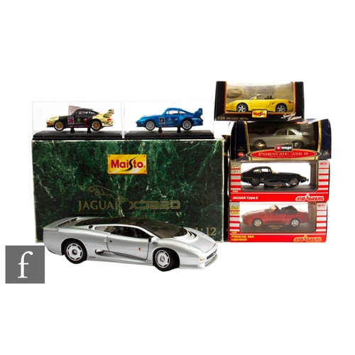 126 - A collection of larger scale diecast models, to include a Maisto 1:12 scale Jaguar XJ220, and six 1:... 