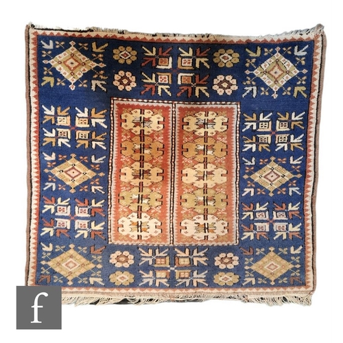 370 - A Turkish Cannakkale woven wool prayer rug, the blue ground rug with central rectangular pink panel,... 