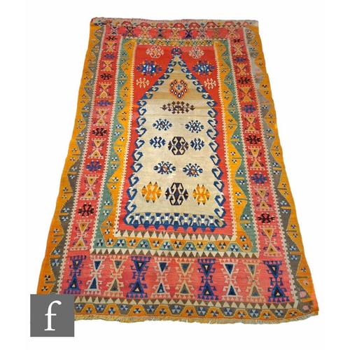 372 - A Turkish Sivas Kilim, circa 1960, the red ground rug with orange and green borders, the central pan... 