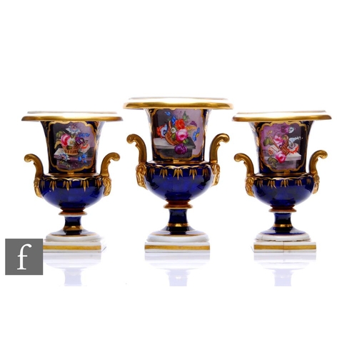 450 - A garniture of Derby porcelain urns, circa 1820, each of campana form, raised on a square section ba... 