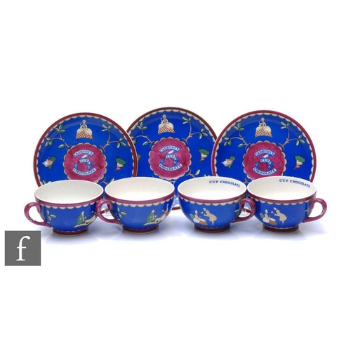 A set of 1920s Wedgwood Cadbury's chocolate advertising cups and saucers, each decorated with blue ground and inner cup text 'Cup Chocolate', four cups and three saucers, saucer diameter 15cm. (7)